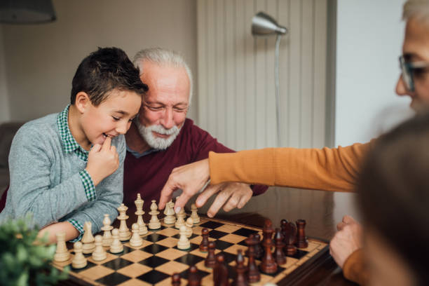 istock Grandparents playing chess with grandchild 1080295302