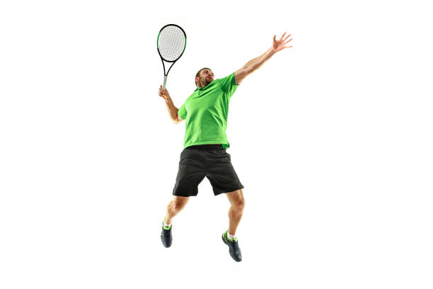 un uomo caucasico che gioca tennista isolato su sfondo bianco - tennis men indoors serving foto e immagini stock