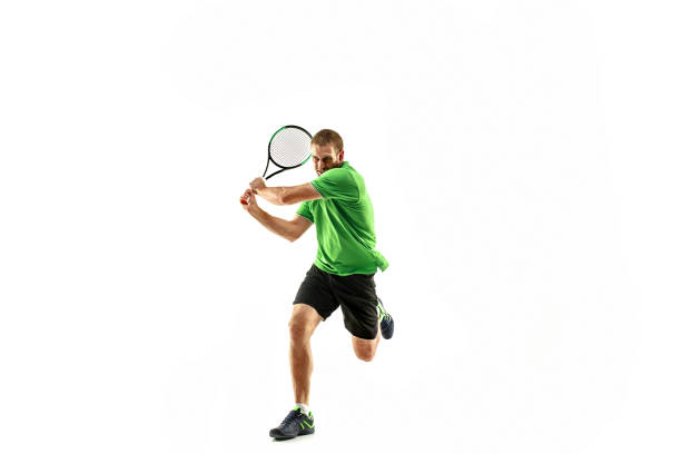 un uomo caucasico che gioca tennista isolato su sfondo bianco - tennis men indoors serving foto e immagini stock