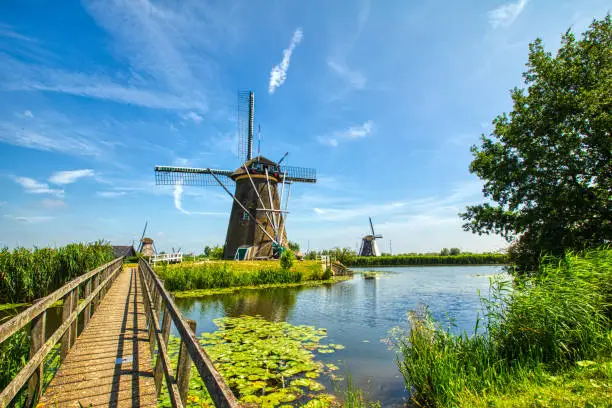 view of traditional windmills in Kinderdijk, The Netherlands. This system of 19 windmills was built around 1740 and is a UNESCO heritage site.