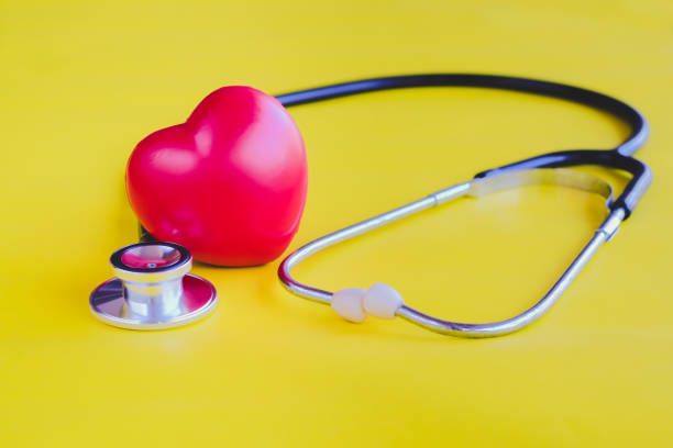 istock Stethoscope with red heart on yellow vintage background. 1080299356