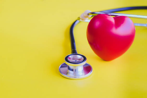 istock Stethoscope with red heart on yellow vintage background. 1080299366