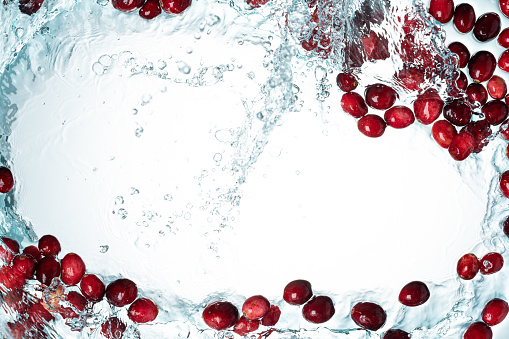 Cranberries Water Splash on White Background