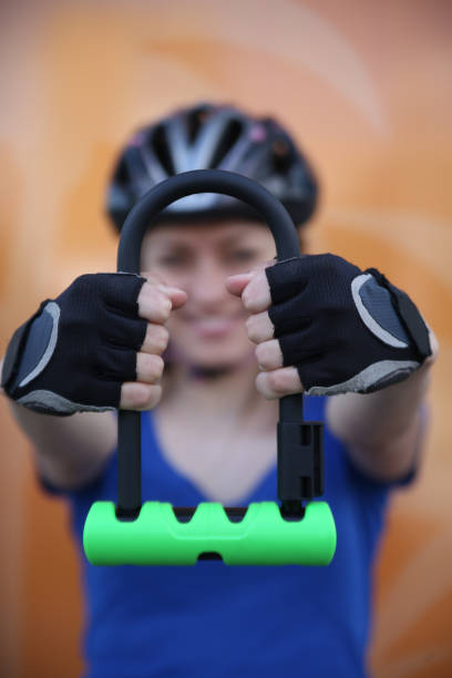 istock Girl with bicycle  lock. Bicycle U- lock 1080305614
