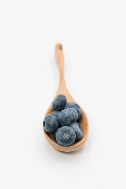 istock blueberry in the wooden spoon 1080308598