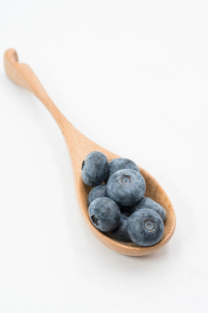 istock blueberry in the wooden spoon 1080308676