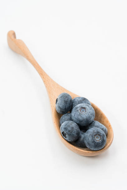 istock blueberry in the wooden spoon 1080308680