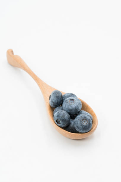 istock blueberry in the wooden spoon 1080308682