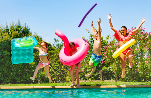 istock Joyful kids having fun during summer pool party 1080308774