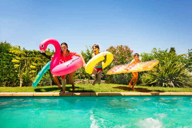 istock Friends with swim tools running to swimming pool 1080309294