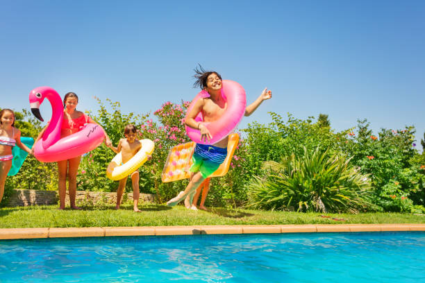 istock Boy in swim ring playing pool games with friends 1080309300