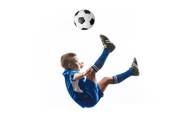 istock Young boy with soccer ball doing flying kick 1080310356
