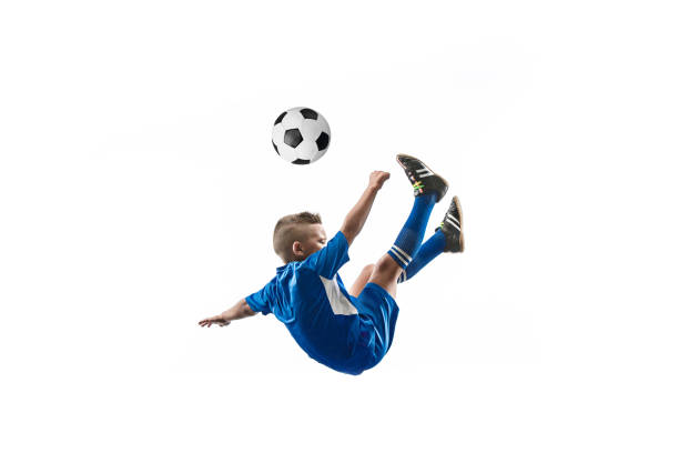 istock Young boy with soccer ball doing flying kick 1080310358