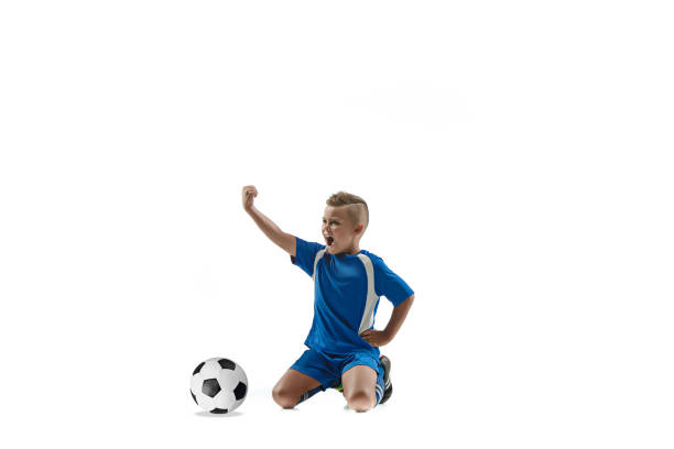 istock Young boy with soccer ball doing flying kick 1080310374