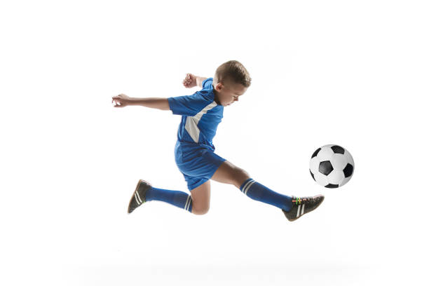 istock Young boy with soccer ball doing flying kick 1080310450