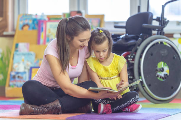 istock A teacher reads to a disabled student 1080310466