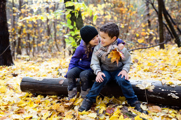 istock children playing in beautiful autumn park on cold sunny fall day. 1080310692