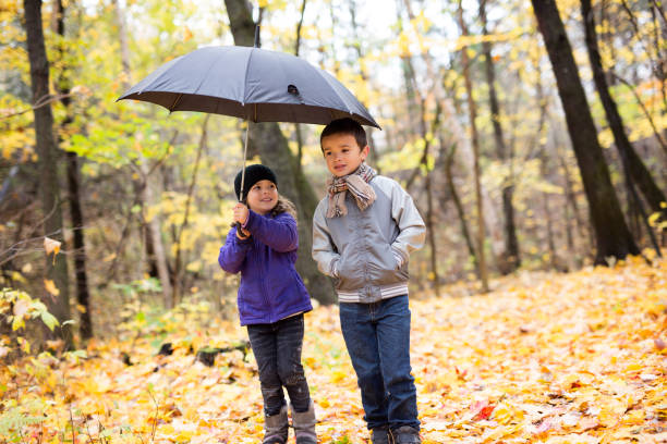 istock Happy children playing in beautiful autumn park 1080310826