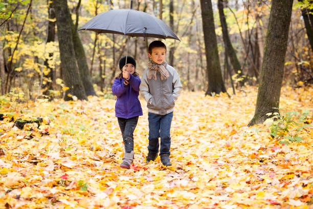 istock Happy children playing in beautiful autumn park 1080310862