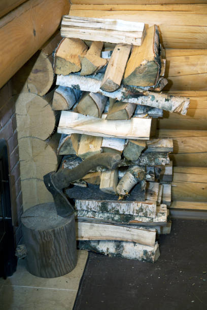 istock ax and pile of split wood in the bath 1080312582