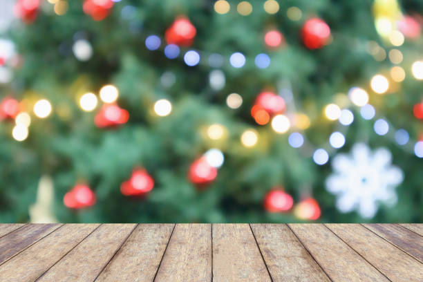 istock Empty wood table top with Abstract blur Christmas tree with decoration bokeh light background for product display 1080312754