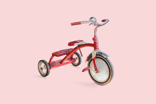 vintage kid red Tricycle on color background. vintage kid red Tricycle on color background. tricycle stock pictures, royalty-free photos & images