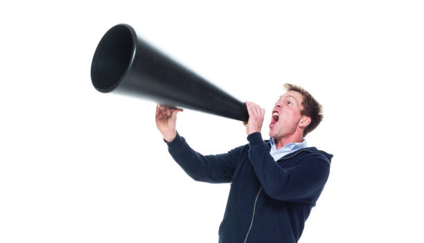 istock Attractive young male using megaphone 1080316474