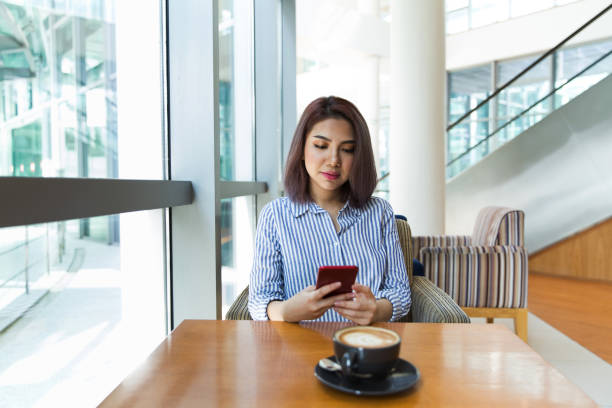 istock Women talking on phone in cafe 1080318736