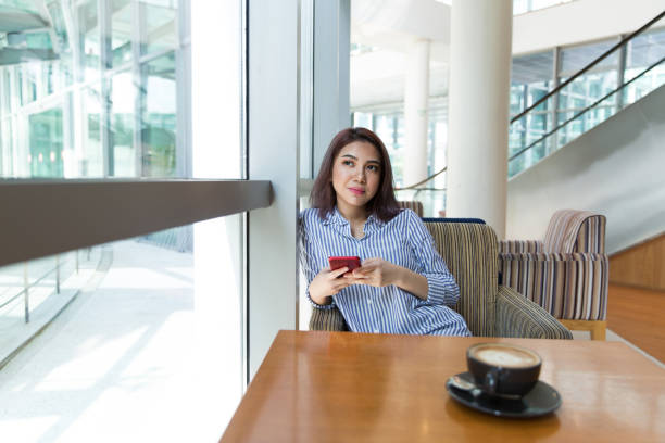 istock Women talking on phone in cafe 1080318782