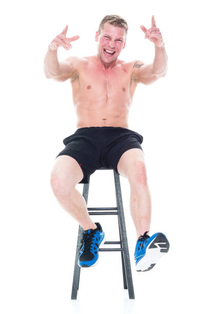 istock Shirtless man sitting on stool and being excited 1080322350