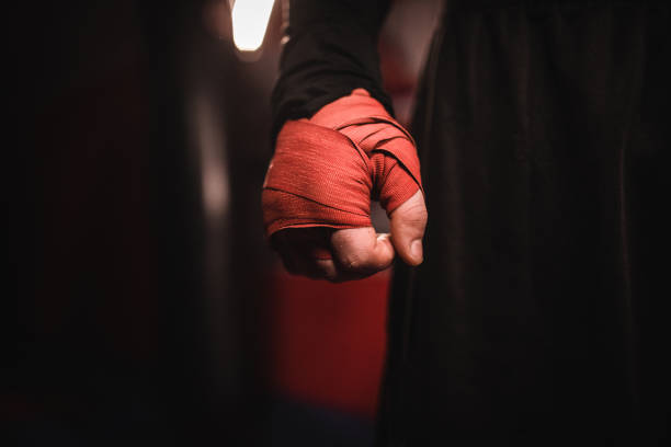 Man hand wrapped in boxing bandages One man, kickboxer with wrapped boxing bandages on hand. combat sport stock pictures, royalty-free photos & images