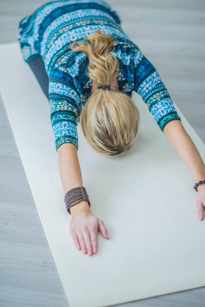 istock A woman practising yoga alone in a studio 1080332198