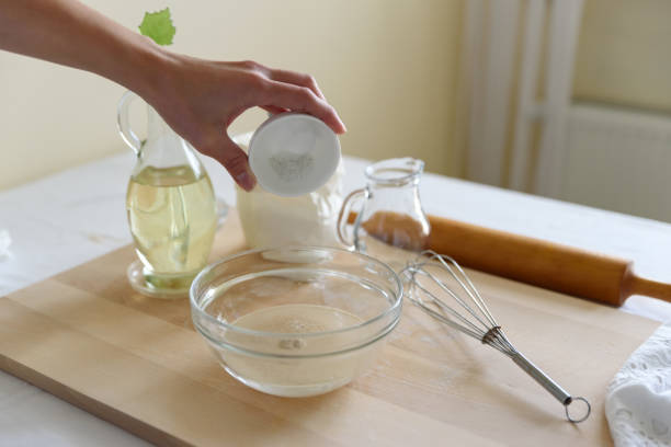 istock Cooking pizza. Mixing ingredients for pizza or bread. Woman hands preparing dough. Selective focus. Back view 1080338230