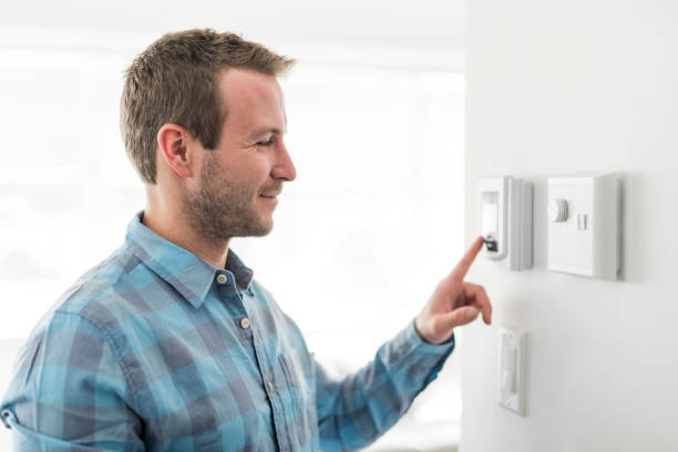 istock A nice man set the thermostat at house. 1080338380
