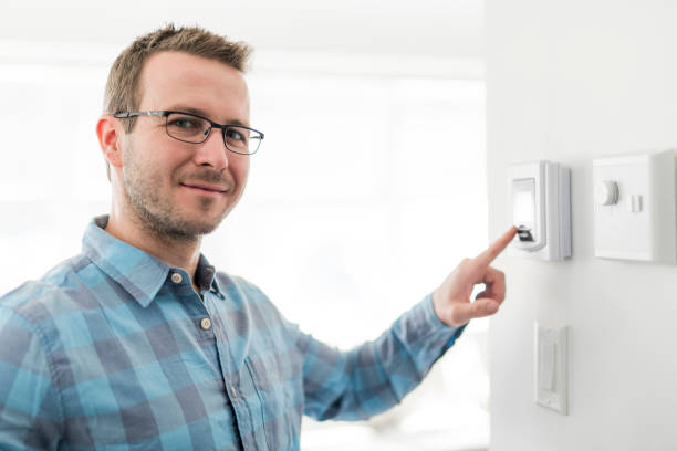 istock A nice man set the thermostat at house. 1080338384