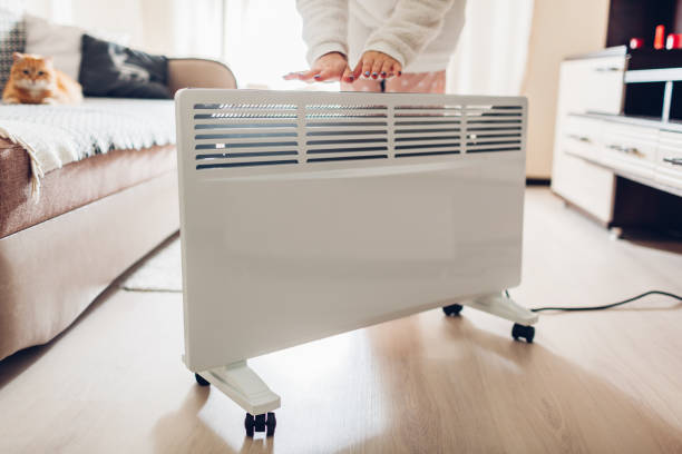 istock Using heater at home in winter. Woman warming her hands. Heating season. 1080342582