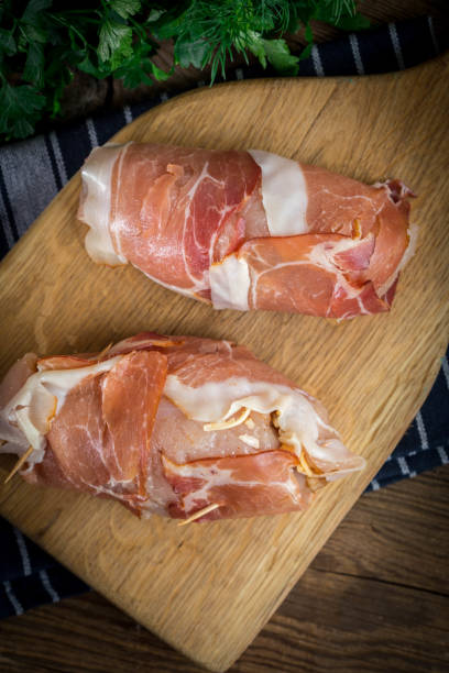 istock Raw chicken breast stuffed with champignon wrapped with bacon. 1080344064