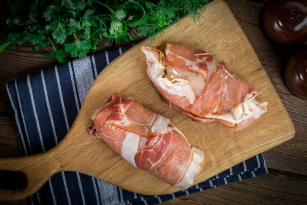 istock Raw chicken breast stuffed with champignon wrapped with bacon. 1080344088