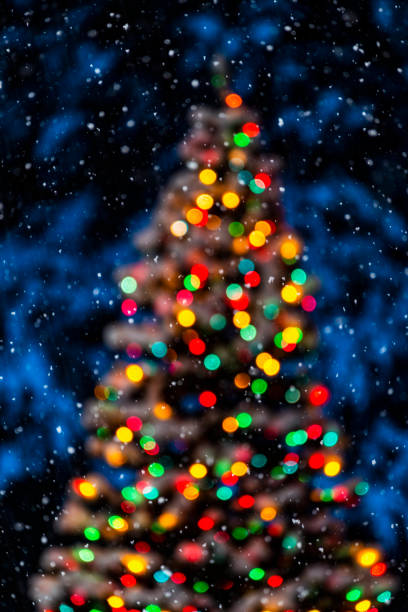 istock Snowy Christmas night with bokeh Christmas tree lights - Background 1080344574