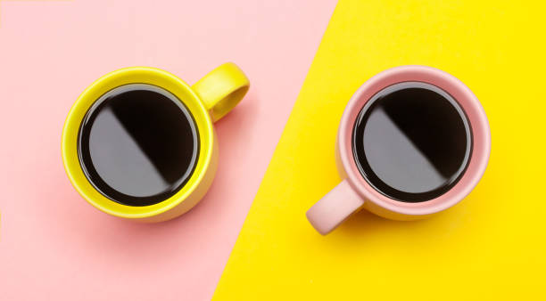 istock Flat lay of a two coffee cups with pink and yellow 1080344772