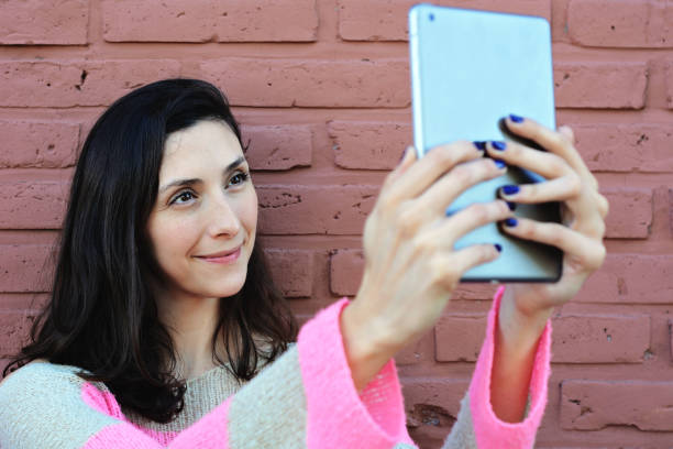 istock Young woman taking selfie with her tablet 1080344788