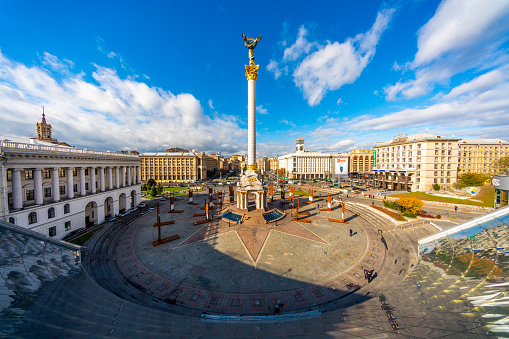 Kiev, Ukraine - October 26, 2018: Kiev  view showing Independence Square Founders Monument, buildings, tower, trees, street cars and buses with people can be seen on the background