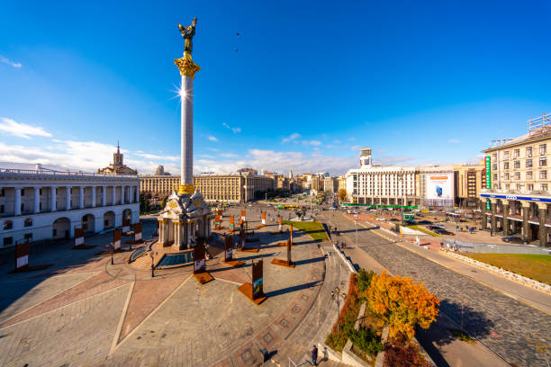 Kiev, Ukraine - October 26, 2018: Kiev  view showing Independence Square Founders Monument, buildings, tower, trees, street cars and buses with people can be seen on the background