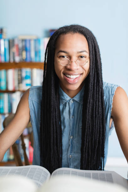 istock Caribbean man with dreadlocks in the library 1080347484