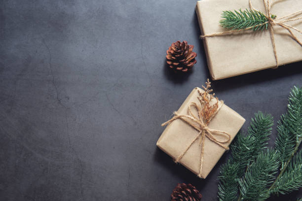istock Christmas gift boxes pine branches on black background. Flat lay, top view 1080351234