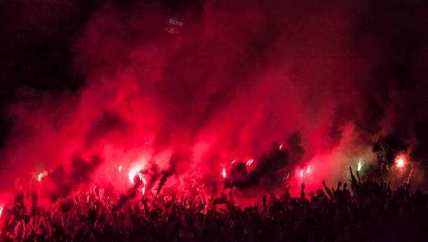 Football fans lit up the lights, flares and smoke bombs Football fans lit up the lights, flares and smoke bombs football fans in stadium stock pictures, royalty-free photos & images
