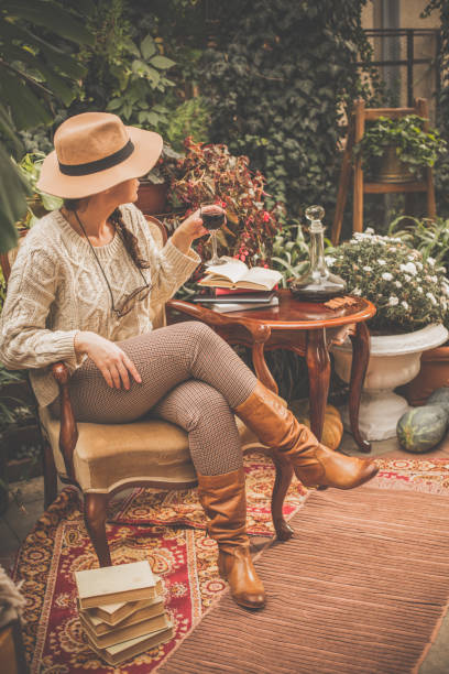 istock Woman relaxing and drinking wine in back yard 1080357098