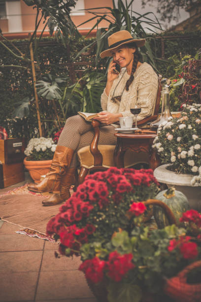 istock Woman talking on cell phone while relaxing in back yard 1080357114