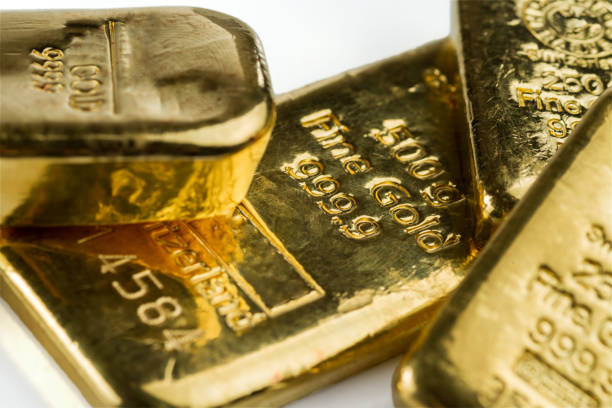 istock Several cast gold bars of different weights isolated on white background. 1080358628
