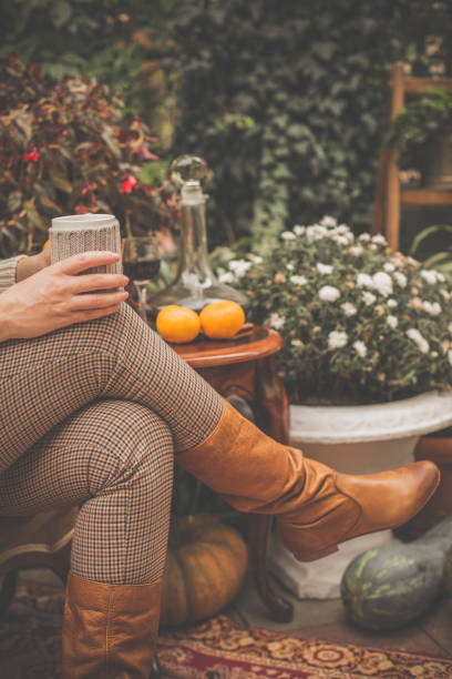 istock Woman having hot drink in back yard 1080359290